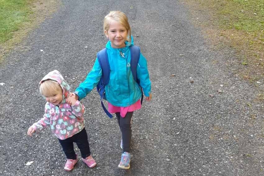 2 little girls walking down path